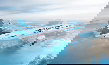 A jetliner flying high above the clouds