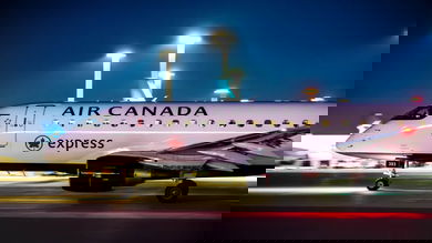 White Air Canada plane taxiing at night