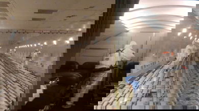 Disinfectant teams spray plane's cargo hold