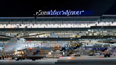 Rear view of plane parked at gate at Frankfurt Airport, nighttime