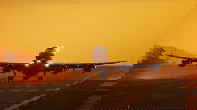 Plane landing in sunset