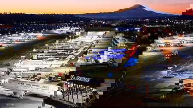 Sunset over Boeing plant with planes parked outside.