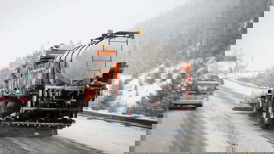 Plows clearing snowy Colorado highway.