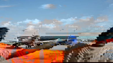 Southwest ground worker directs a plane where to go.