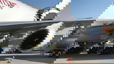 Close up of a white cargo plane being loaded.