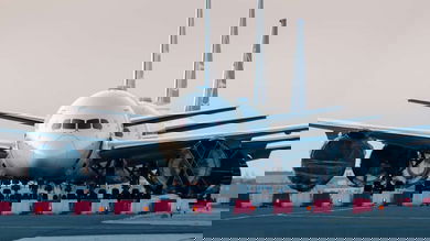 Line of planes pointed straight at camera on runway.