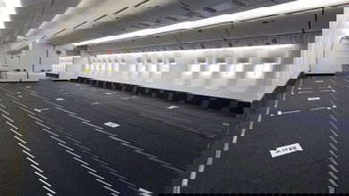 Passenger cabin of plane with seats removed for cargo.