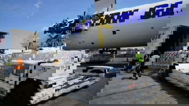 Cargo loaded onto a big white cargo plane.