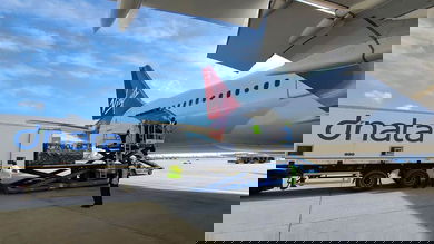Cargo loaded from truck onto plane.