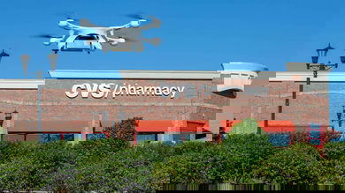 A drone takes off outside a CVS store to make a delivery.