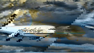 A white jet comes in for landing.