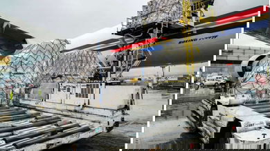 Pallets of cargo are unloaded from a big plane.