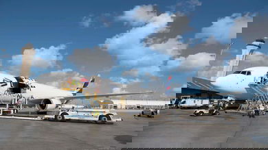Cargo being unloaded from a large white cargo jet.