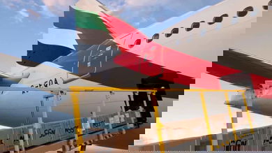 Cargo ets loaded via conveyor belt onto rear of a plane.