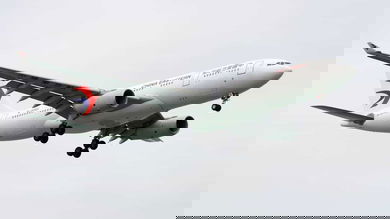 Bit white plane with Chinese markings comes in for landing.