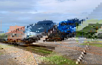 A photograph of a train leaving a train station.