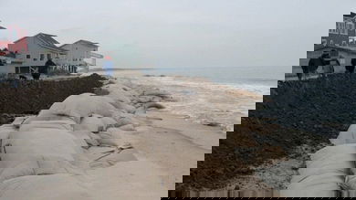 Sand bags piled up along a U.S. beach to prevent flooding.
