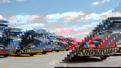 ENTREC's fleet includes semi-trucks for heavy haul transportation like the ones seen parked.