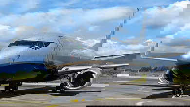 A silver Boeing 737 on the ground, close up view looking at the cockpit from outside.