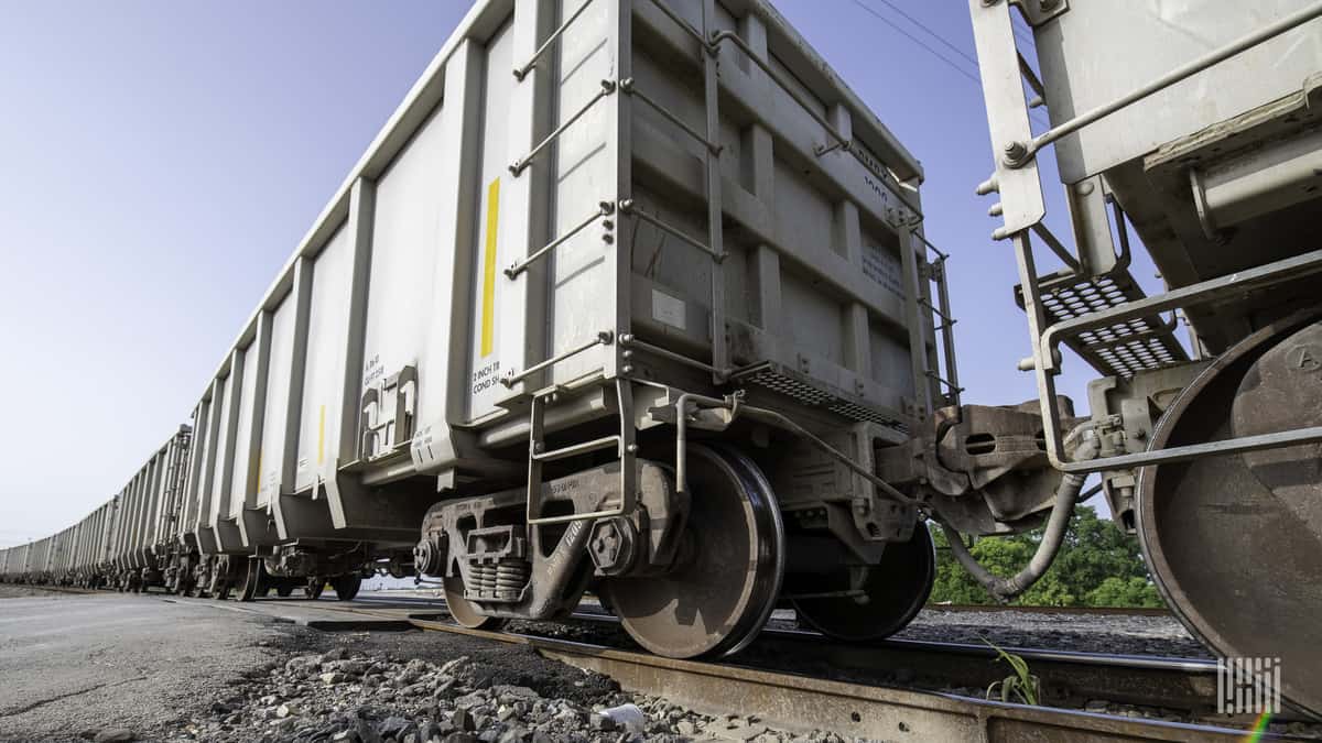 A line of hopper railcars showing the newer heavy-duty/heavy-weight axles.