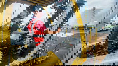 Delta Air Lines cargo worker driving a forklift.