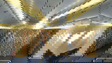 Boxes stored in cabin where passenger seats normally go.