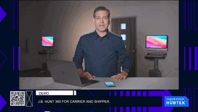 Man standing behind computer and phone talking