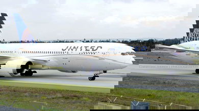 Big United plane on tarmac, side view close up.