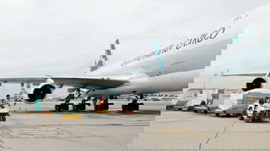 A cargo tug drops off a load next to a Cathay Pacific jet. The air cargo business in June was down a fifth from last year's level.