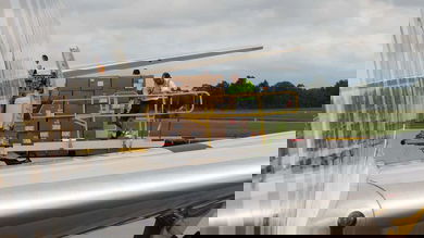 Pallets of freight offloaded an Emirates 777 passenger plane onto a hydraulic lift. The use of passenger planes as freighters is dictated by strong market economics.