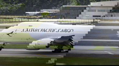 A white Cathay Pacific jumbo jet gets ready to takeoff. Cathay Pacific is bolstering its cargo team with new additions.