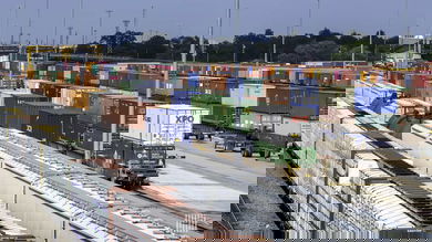 A photograph of parked intermodal containers and trains at a rail yard.