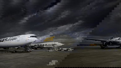 Atlas Air 747 freighters parked under a dark sky. Atlas Air announced a large Q2 profit.