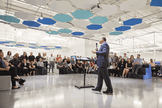Bob Farrell speaks to GlobalTranz employees in 2018.