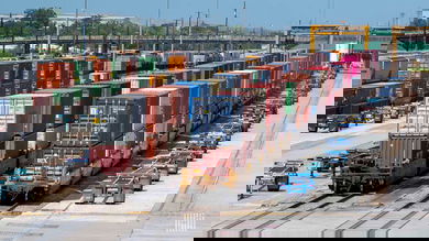 A photograph of intermodal containers parked at a rail yard.