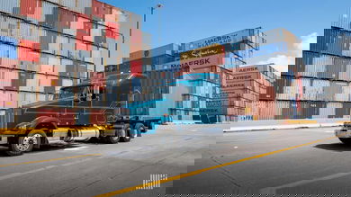 Drayage truck at port surrounded by containers