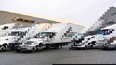 Three parked trucks from Pacific Coast Express, a Canadian less-than-truckload carrier recently acquired by Mullen Group.