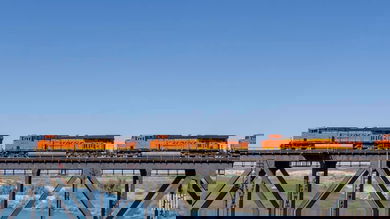A photograph of three BNSF locomotives crossing a bridge.