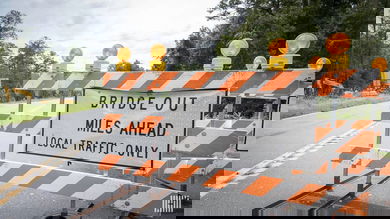 "Road Closed: Bridge Out" sign on a highway.