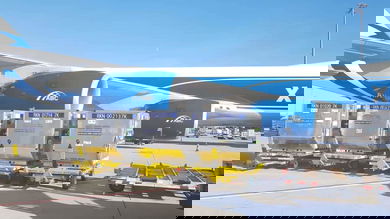 A big blue cargo jet with a white top gets ready to receive temperature-controlled containes.