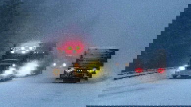Trucks and cars on a snowy Washington state highway.