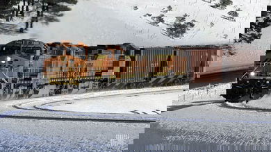 A photograph of a BNSF train traveling through a snowy landscape.