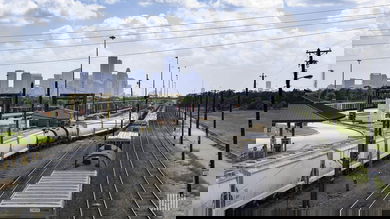 A photograph of a rail yard with city skyscrapers in the background.