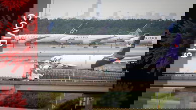 Airplanes parked, moving at airport. Truck driving on ramp. Lots of activity at airport.
