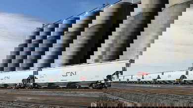 A photograph of grain elevators and a train next to them.