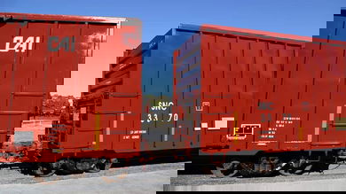 A photograph of two railcars on a train track.