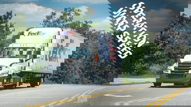 White FedEx truck driving on highway, headed towards us with Operation Warp Speed banner on side of photo for vaccine distribution effort.
