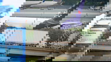 Graphic image with a vaccine vial on one side, FedEx aircraft on the other