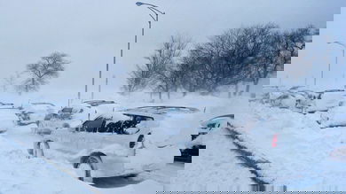 Cars parked in deep snow.