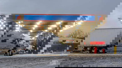 Drivers at a truck stop on a snowy day.